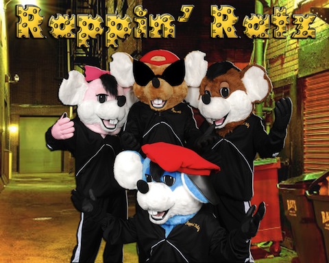 Photo of four presumably men with rat masks