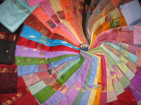 Indian Apparel Store Looking for Funding Folded saris ordered in a circle